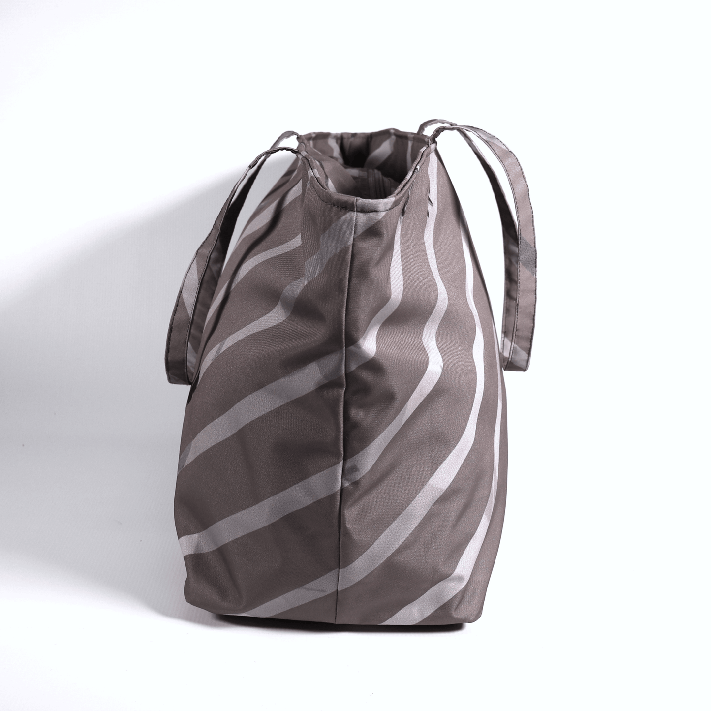 A dark mauve carryall bag with light grey diagonal stripe design. Side view.