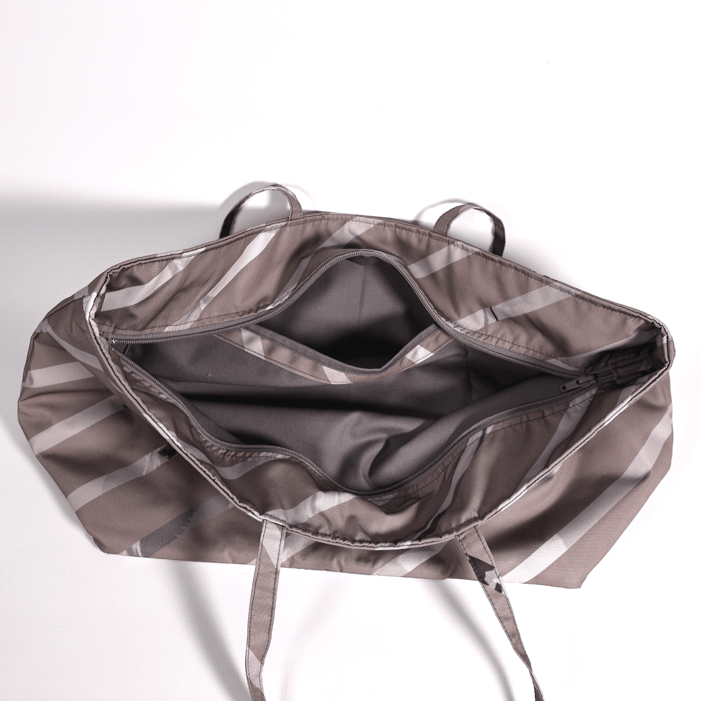 A dark mauve carryall bag with light grey diagonal stripe design. Top view.