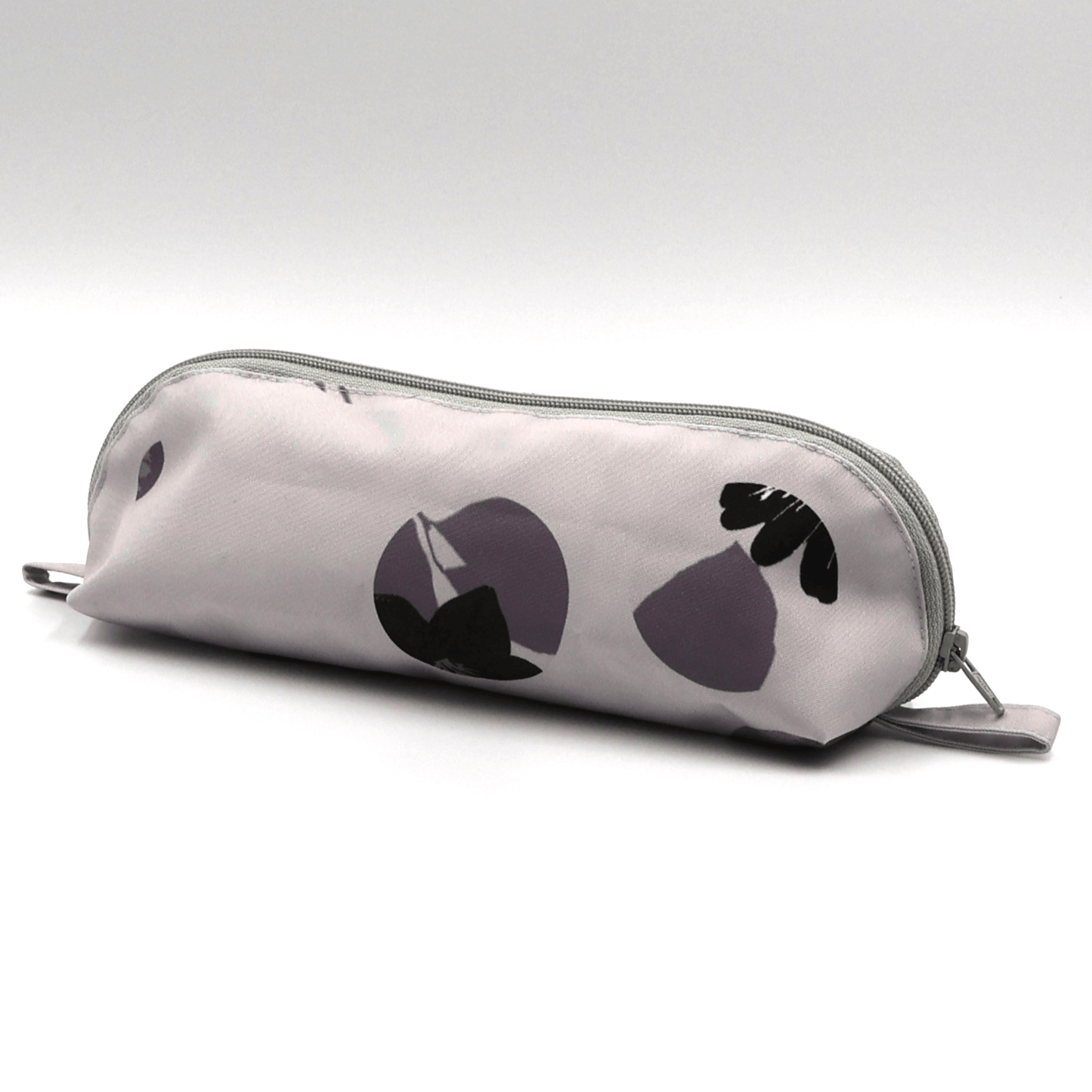 Pencil bag in soft mauve and dark grey daisy floral design on dusky mauve background. Side view.