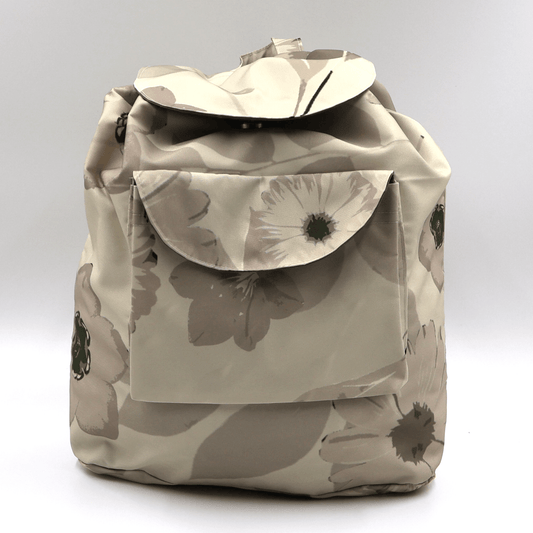 Lightweight backpack with drawstring and daisy floral design in dark and light beige and ivory.