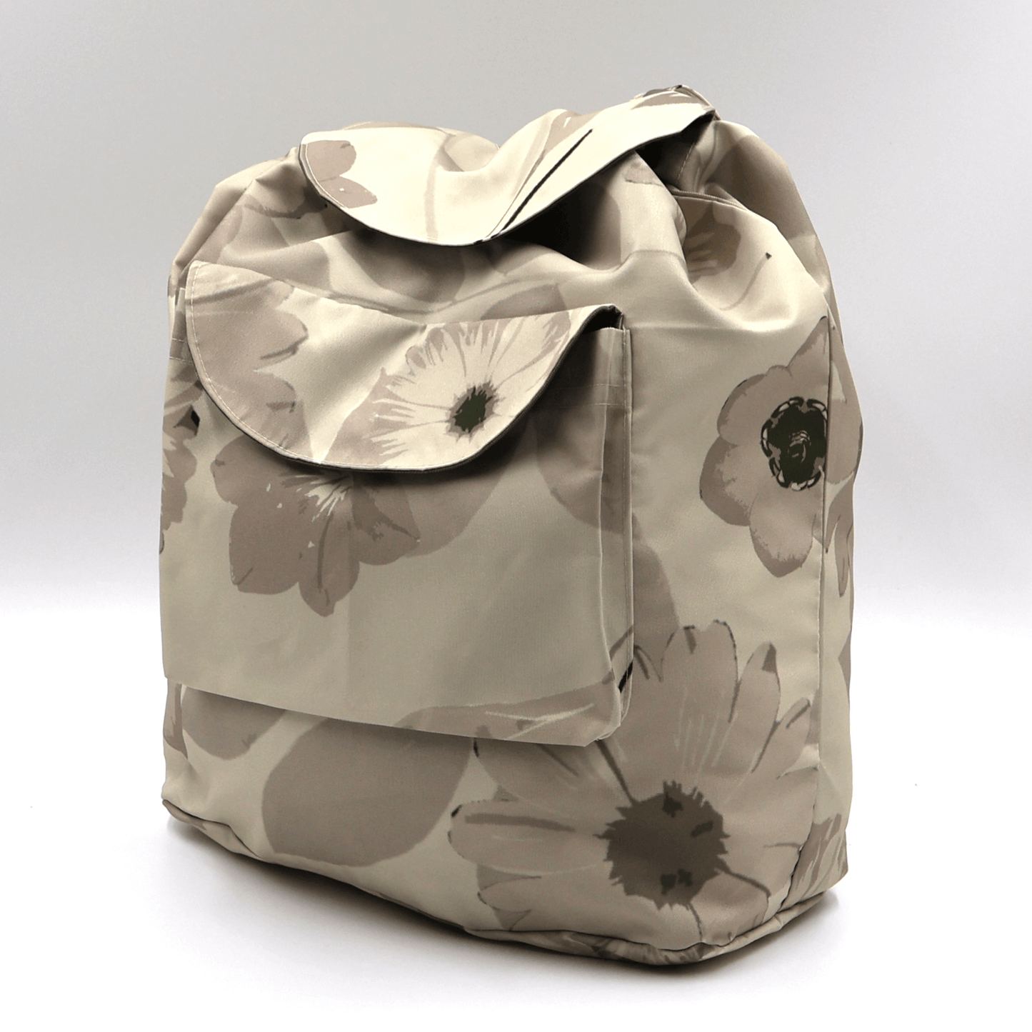 Lightweight backpack with drawstring and daisy floral design in dark and light beige and ivory. Side View.