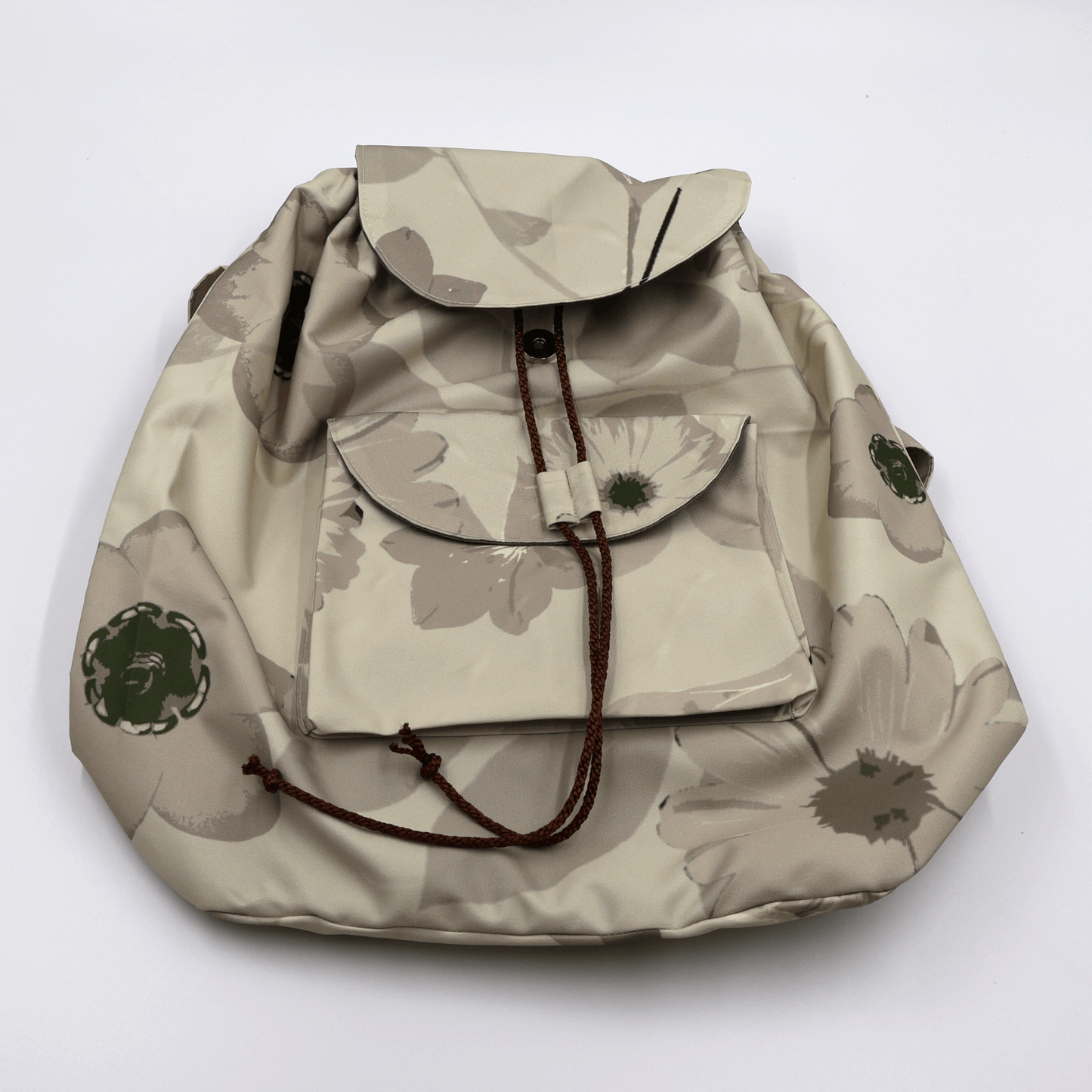 Lightweight backpack with drawstring and daisy floral design in dark and light beige and ivory. Flat View.