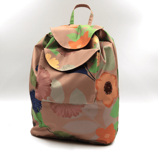 Lightweight backpack with drawstring and orange daisy floral design on dusky peach/orange background.