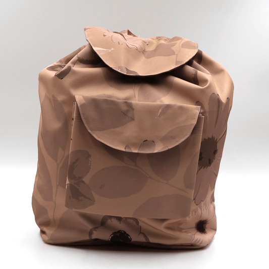 Lightweight backpack with drawstring and daisy floral design in dark and light rusty orange and peach.