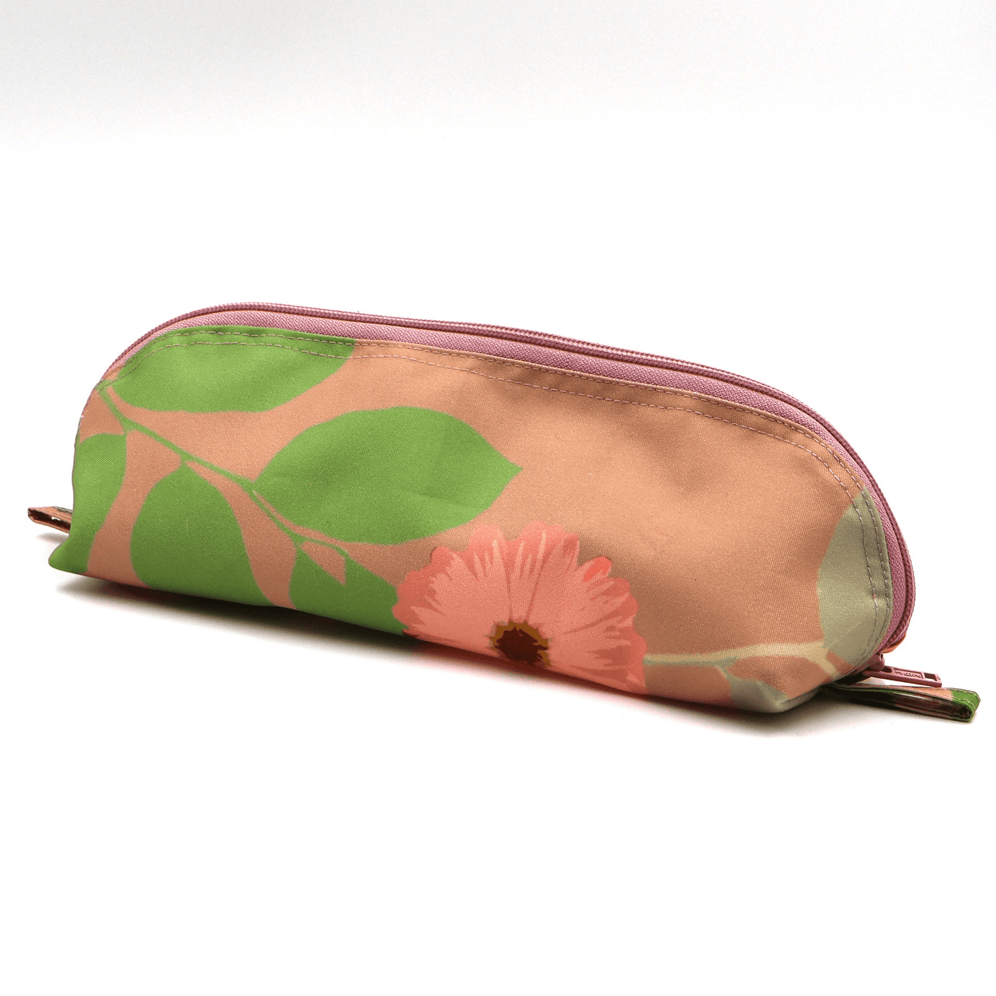 Pencil bag in bright colourful daisy floral design on peach background. Side view.