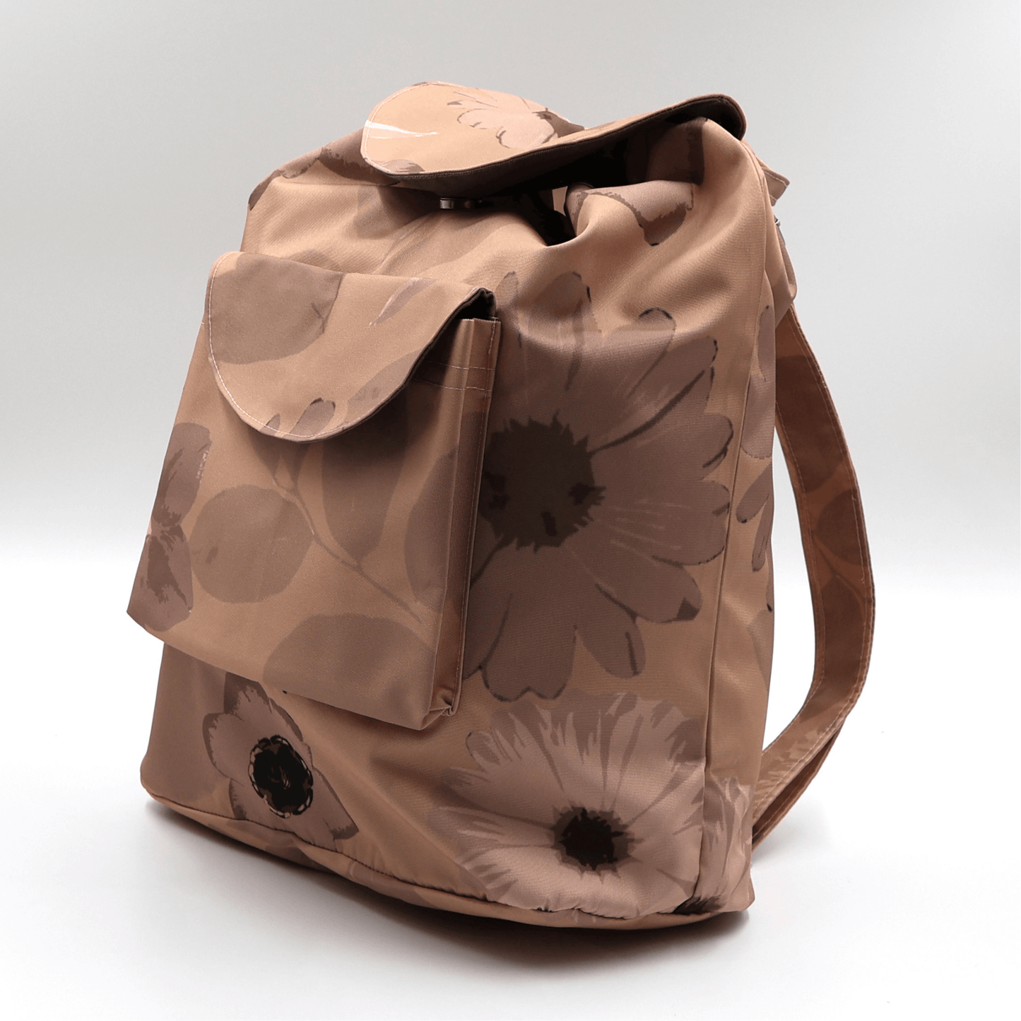 Lightweight backpack with drawstring and daisy floral design in dark and light rusty orange and peach. Side angle.