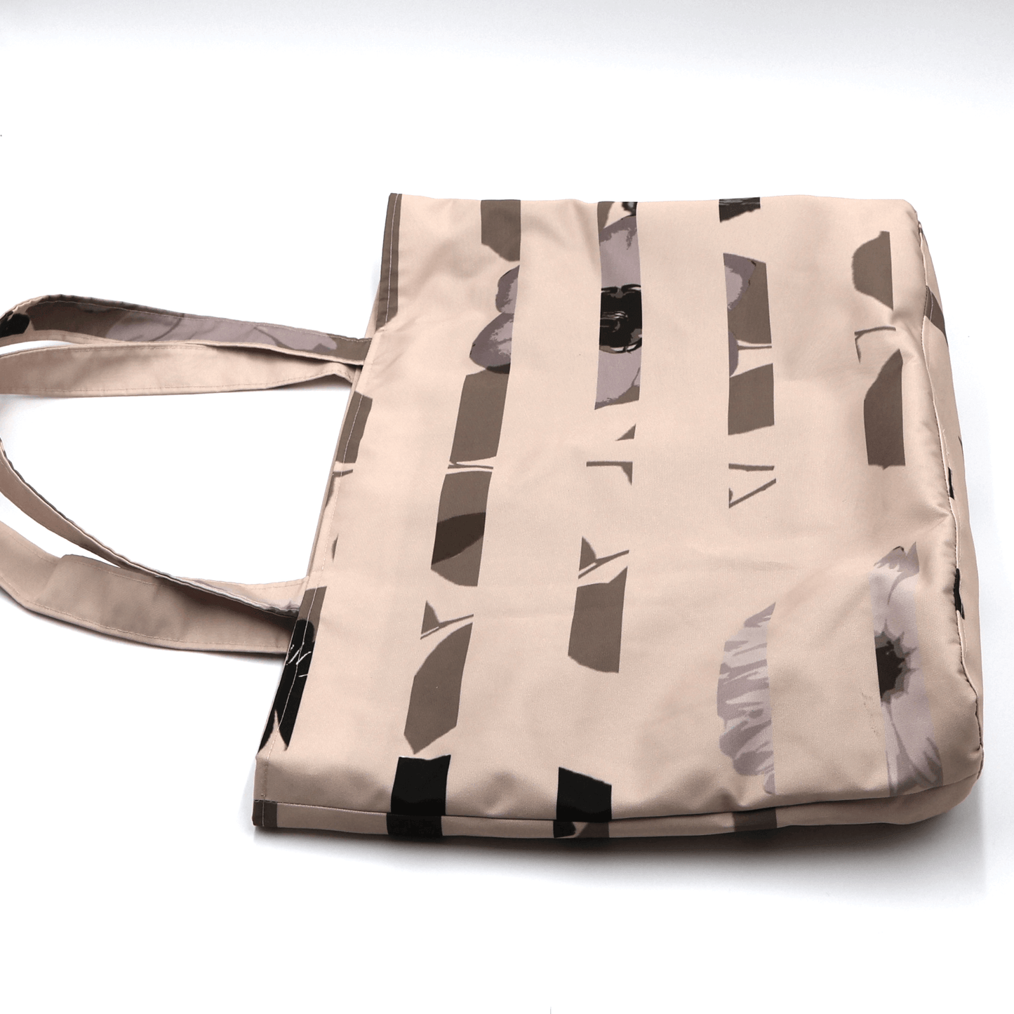 Shoulder bag with stripe/floral design in dusky peach and brown. Perfect for carrying books and documents. Flat view.