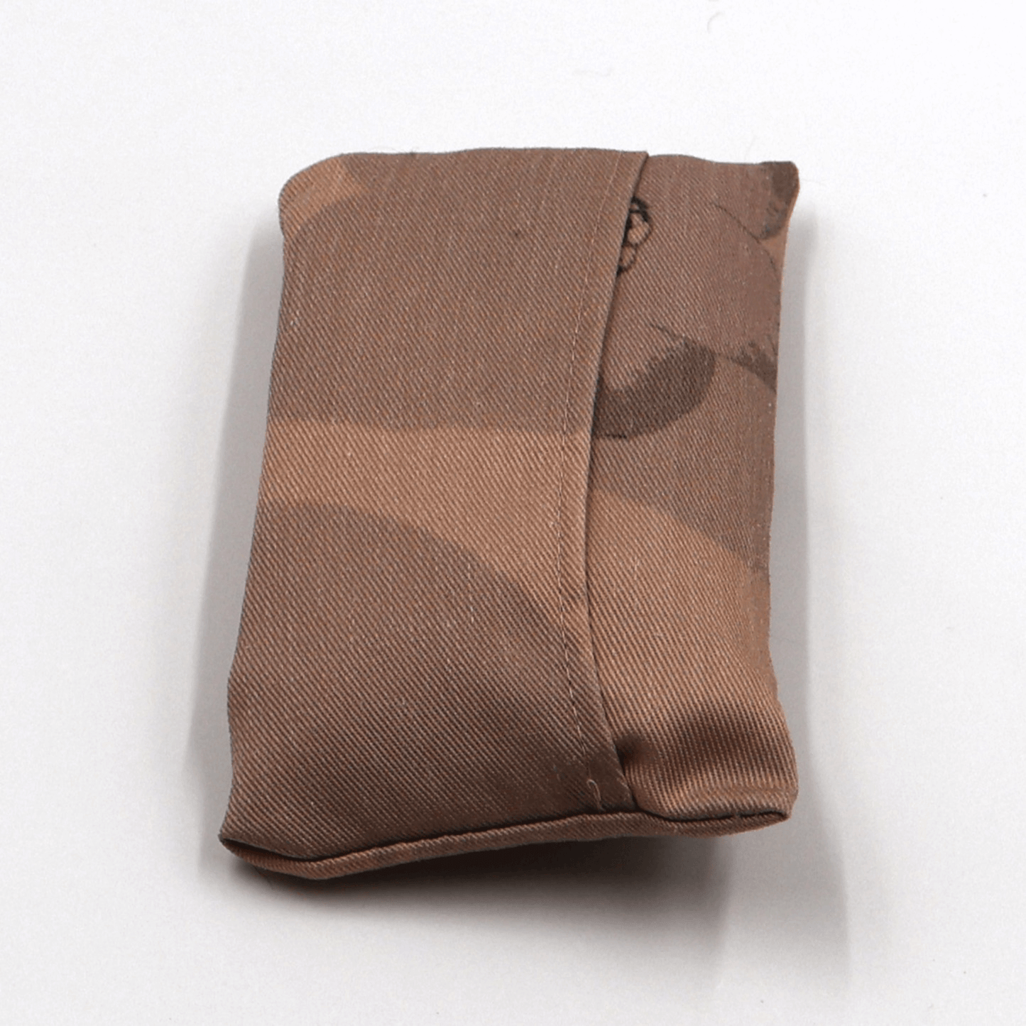 Fold up shopping bag in daisy floral design on peach background. Back view.