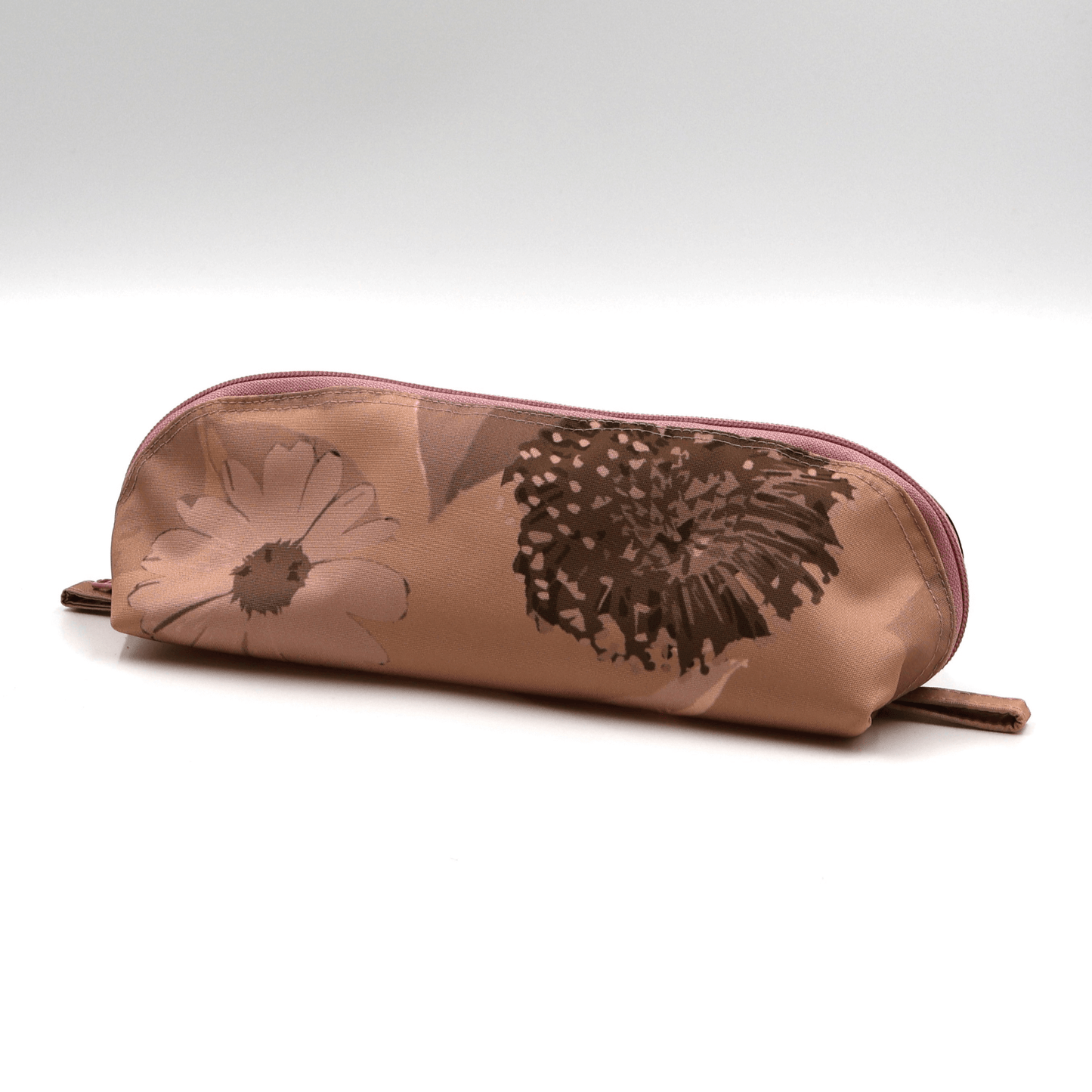 Pencil bag in rusty orange and brown daisy floral design on dusky orange background. Side view.