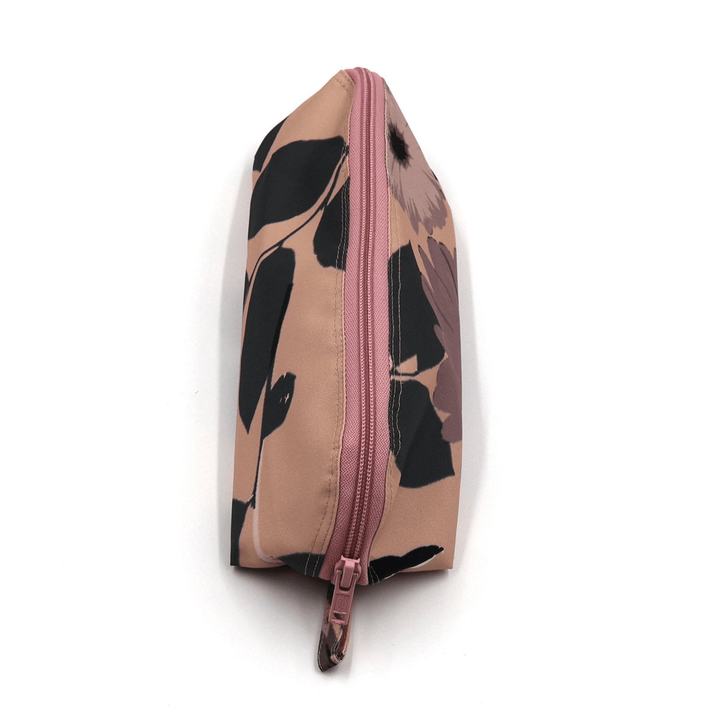 Pencil bag in dusky pink and dark grey daisy floral design on soft peach background. Top view.