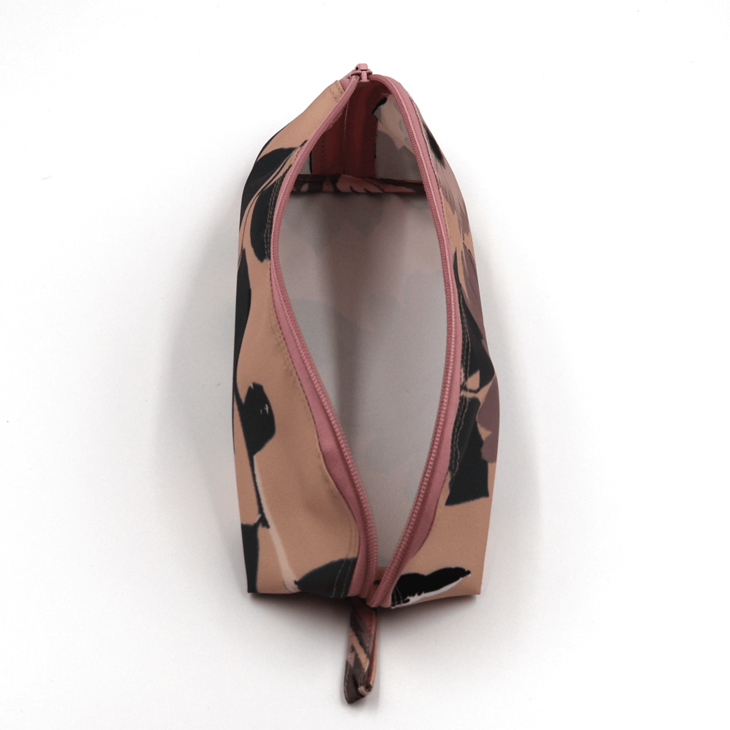 Pencil bag in dusky pink and dark grey daisy floral design on soft peach background. Top view open.