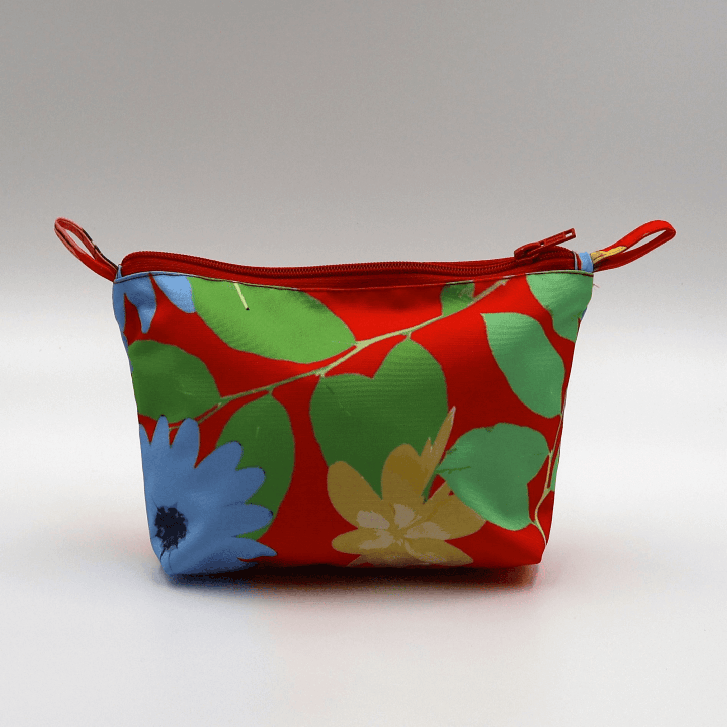 Vibrant red Ellie Makeup Bag with floral design, perfect for storing beauty products, durable and easy to clean.