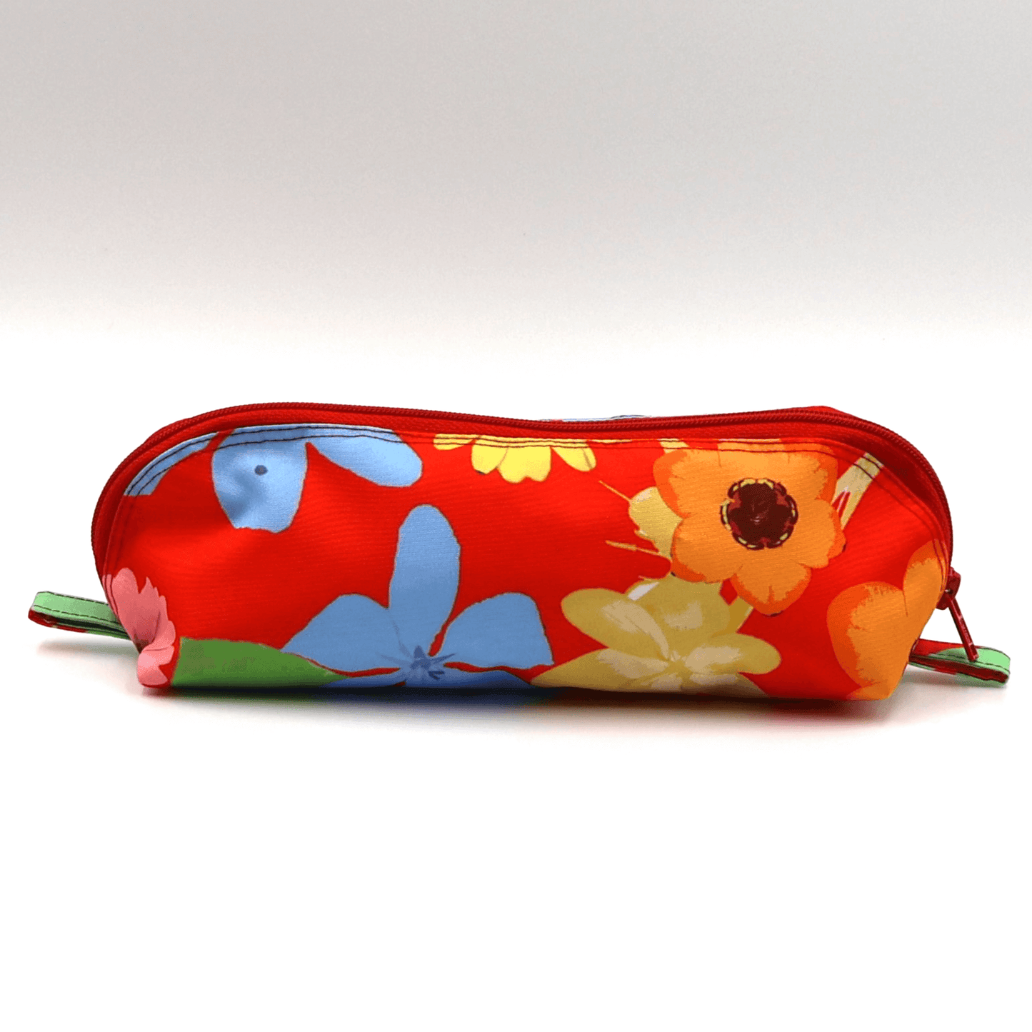 Pencil bag in bright colourful daisy floral design on red background.