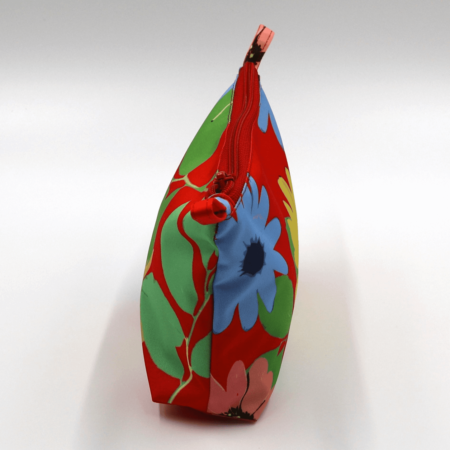 Ellie B Red Darling Makeup Bag side view featuring vibrant floral design and zipped closure for beauty product storage.