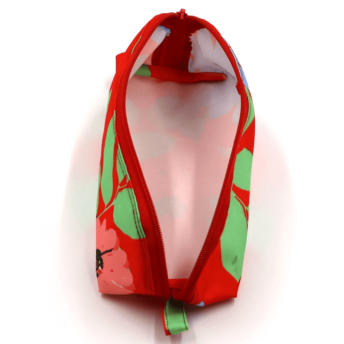 Pencil bag in bright colourful daisy floral design on red background. Top view open.