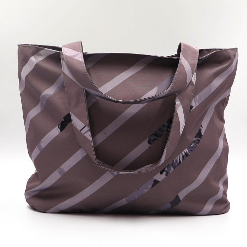 Shoulder bag with stripe design in dark and light mauve. Perfect for carrying books and documents.