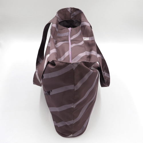 Shoulder bag with stripe design in dark and light mauve. Perfect for carrying books and documents. Top view.