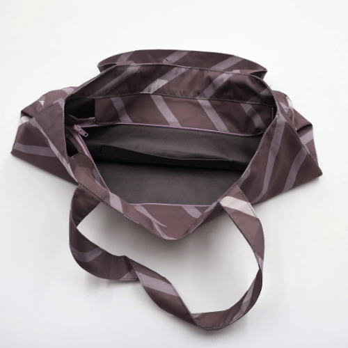 Shoulder bag with stripe design in dark and light mauve. Perfect for carrying books and documents. Inside view.