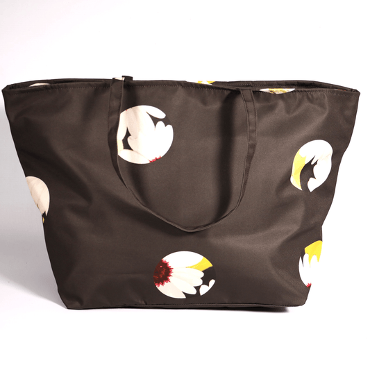 A dark grey/black carryall bag with a white abstract floral design.