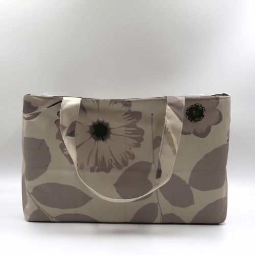 Large teacher/book bag with floral daisy design in dark and light beige and taupe.