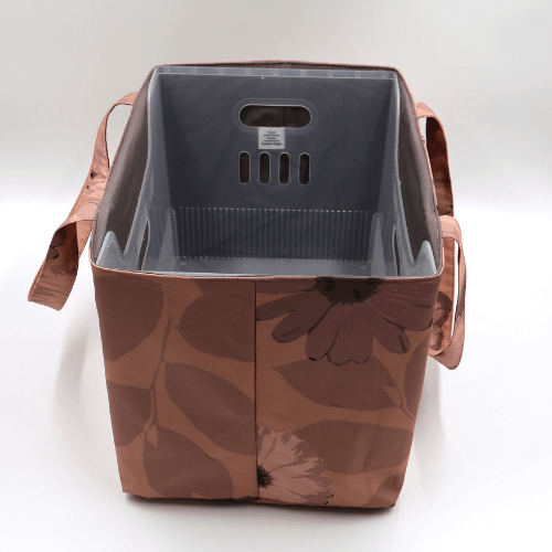 Large teacher/book bag with daisy floral design in rusty orange, brown and dark peach. With plastic inner.