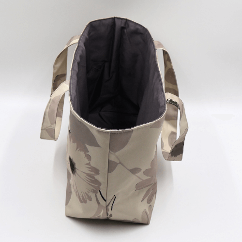 Medium teacher/book bag with floral daisy design in dark and light beige and taupe. Without plastic inner.