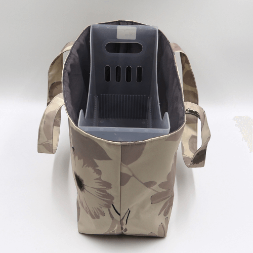 Medium teacher/book bag with floral daisy design in dark and light beige and taupe. With plastic inner.