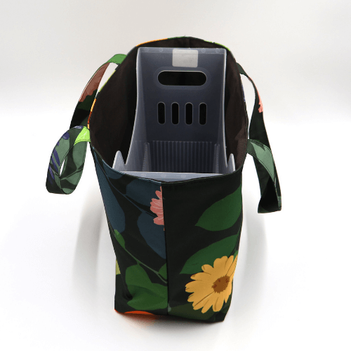 Medium teacher/book bag with bright, daisy design on a black background. With plastic inner.