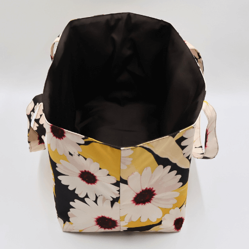 Large teacher/book bag with white, daisy design on a black background. Without plastic inner.