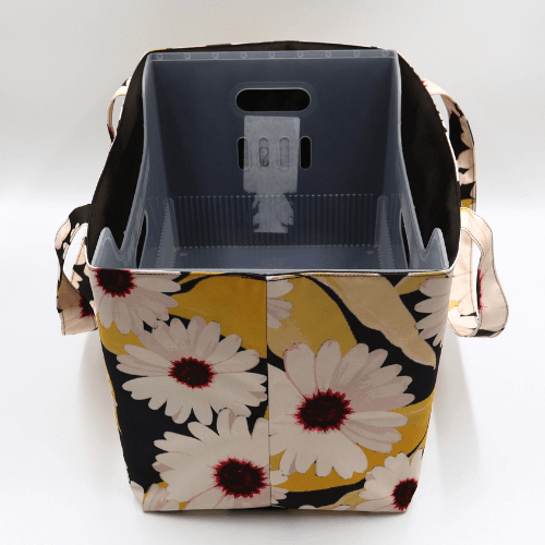 Large teacher/book bag with white, daisy design on a black background. With plastic inner.