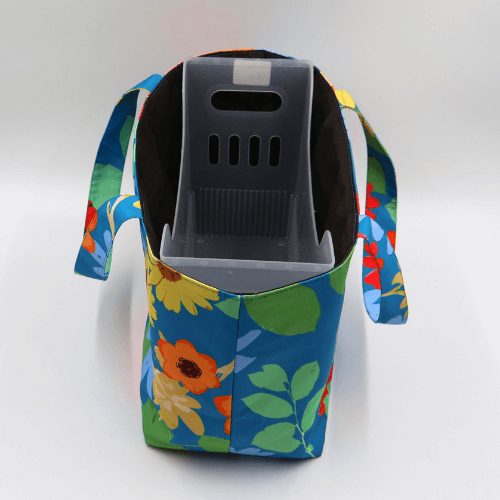 Teacher/book bag with bright floral daisy design on a blue background. Carry books and crafts. Top view with inner.