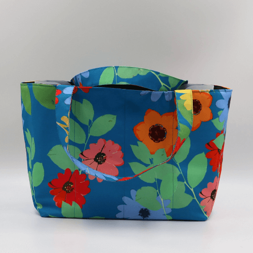 Teacher/book bag with bright floral daisy design on a blue background. Carry books and crafts.