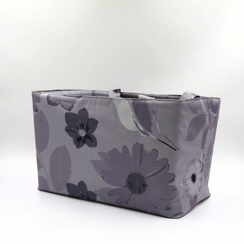 Large teacher/book bag with floral daisy design in dark and light grey on a soft silver-grey background. Side angle.