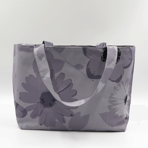 Medium teacher/book bag with floral daisy design in dark and light grey on a soft silver-grey background.