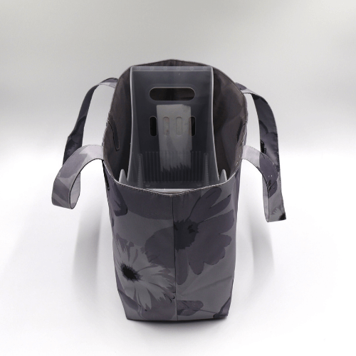 Medium teacher/book bag with floral daisy design in dark and light grey on a soft silver-grey background. Top view with plastic inner.