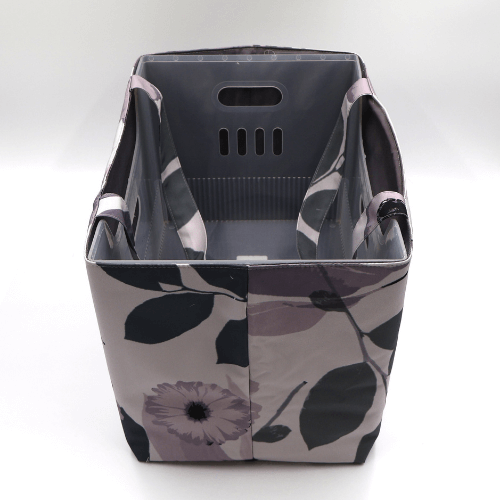 Large teacher/book bag with floral daisy design in dark and light mauve on a soft mauve background. With plastic inner.