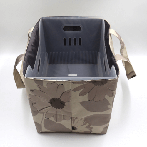 Large teacher/book bag with floral daisy design in dark and light beige and taupe. With plastic inner.