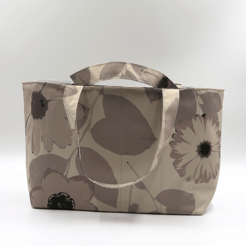 Medium teacher/book bag with floral daisy design in dark and light beige and taupe.