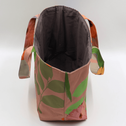 Medium teacher/book bag with bright floral daisy design on a dark peach background. Without plastic inner.