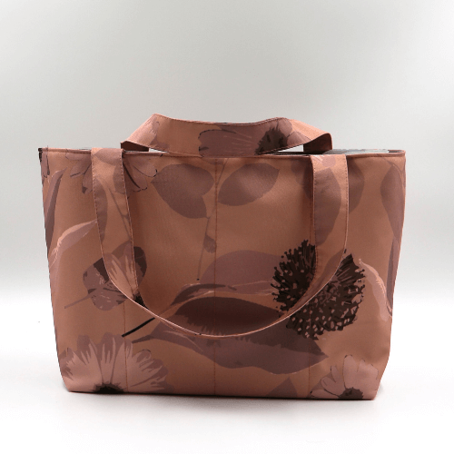 Medium teacher/book bag with daisy floral design in rusty orange, brown and dark peach.