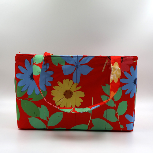 Large teacher/book bag with bright daisy floral design on a red background. Carry books and crafts.