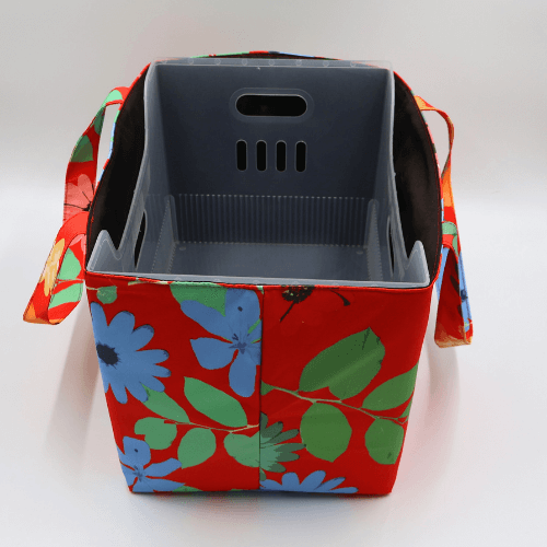 Large teacher/book bag with bright daisy floral design on a red background. With plastic inner.