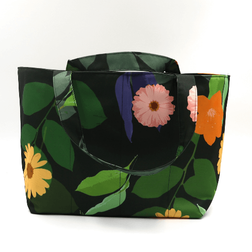Medium teacher/book bag with bright, daisy design on a black background. Carry books and crafts.