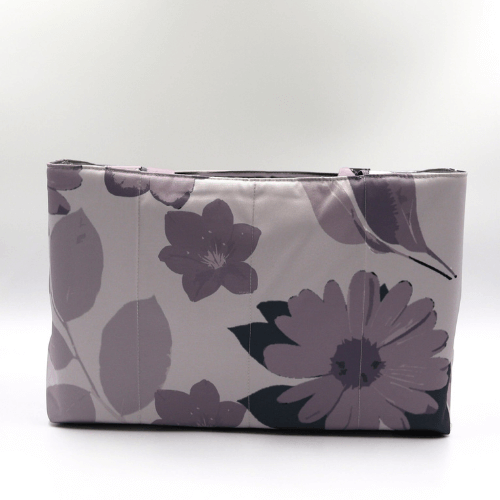 Large teacher/book bag with floral daisy design in dark and light mauve on a soft mauve background.