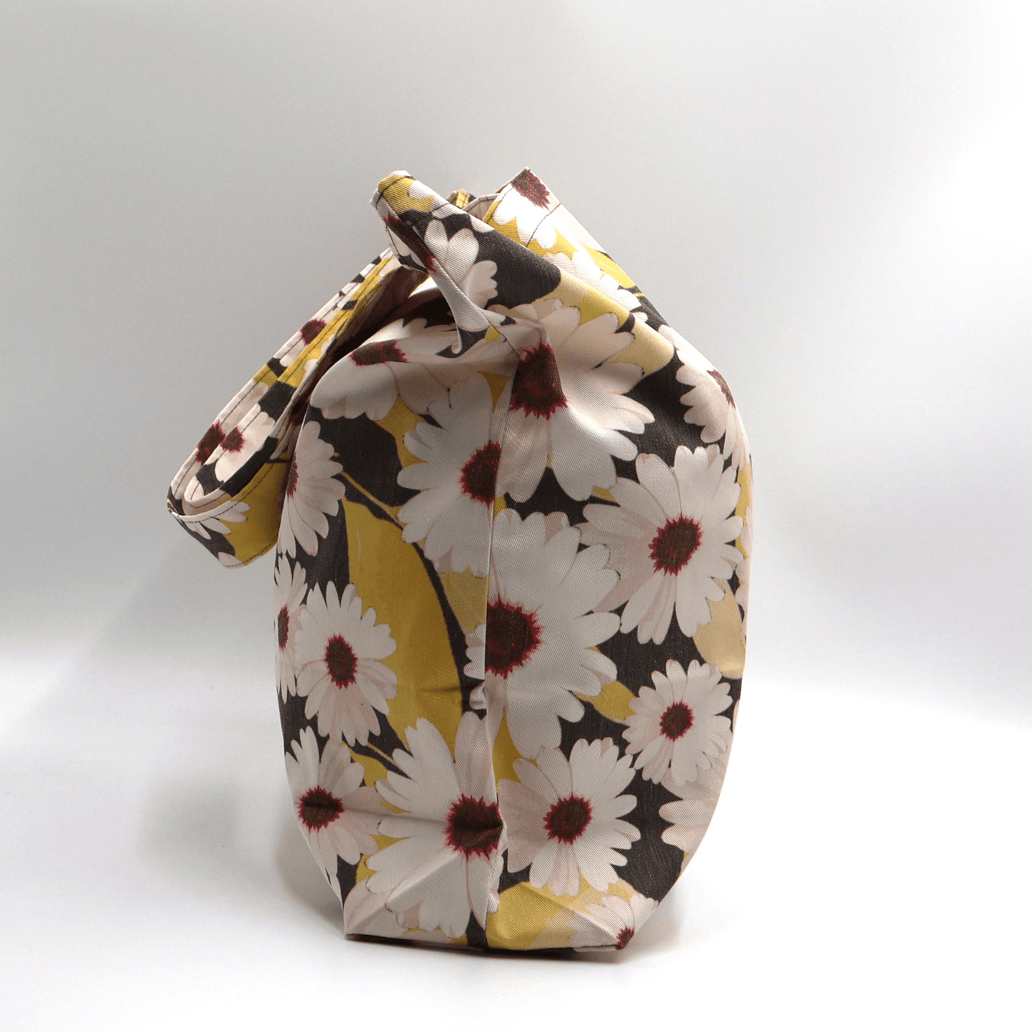A big, durable tote bag with a white Daisy design. Carry all your daily essentials, books or shopping.