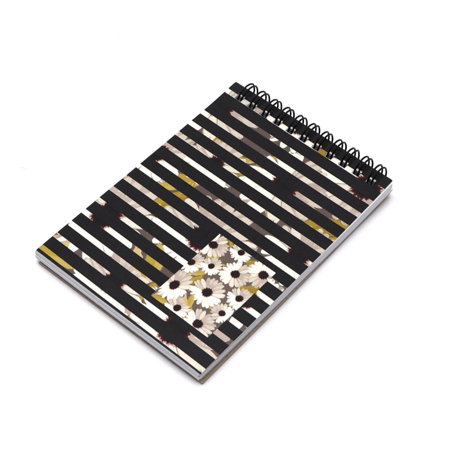 A6 Notebook with geometric white daisy floral design on a black background. Top wire binding.