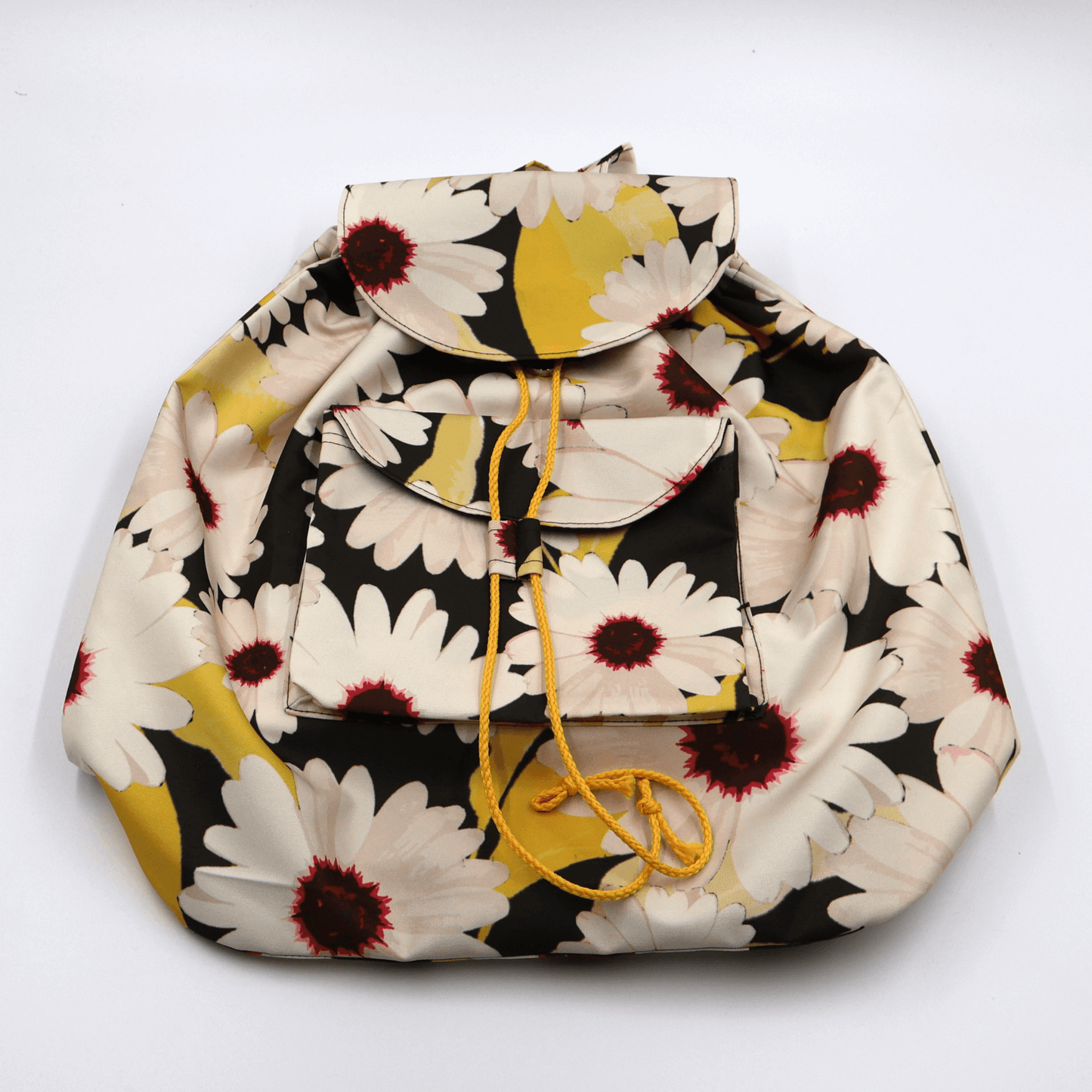 Lightweight backpack with drawstring and white daisy floral design on black background. Flat view.