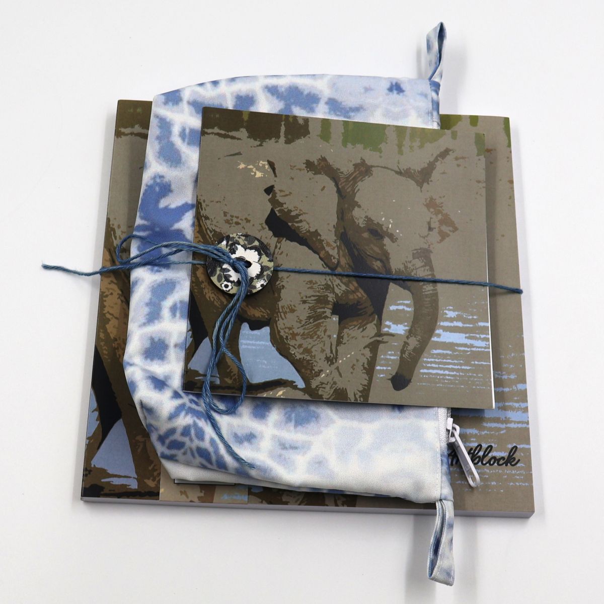 Handmade South African nature gift box neatly arranged with a square baby elephant sketchpad a soft blue zippered canvas pencil bag and a matching animal greeting card