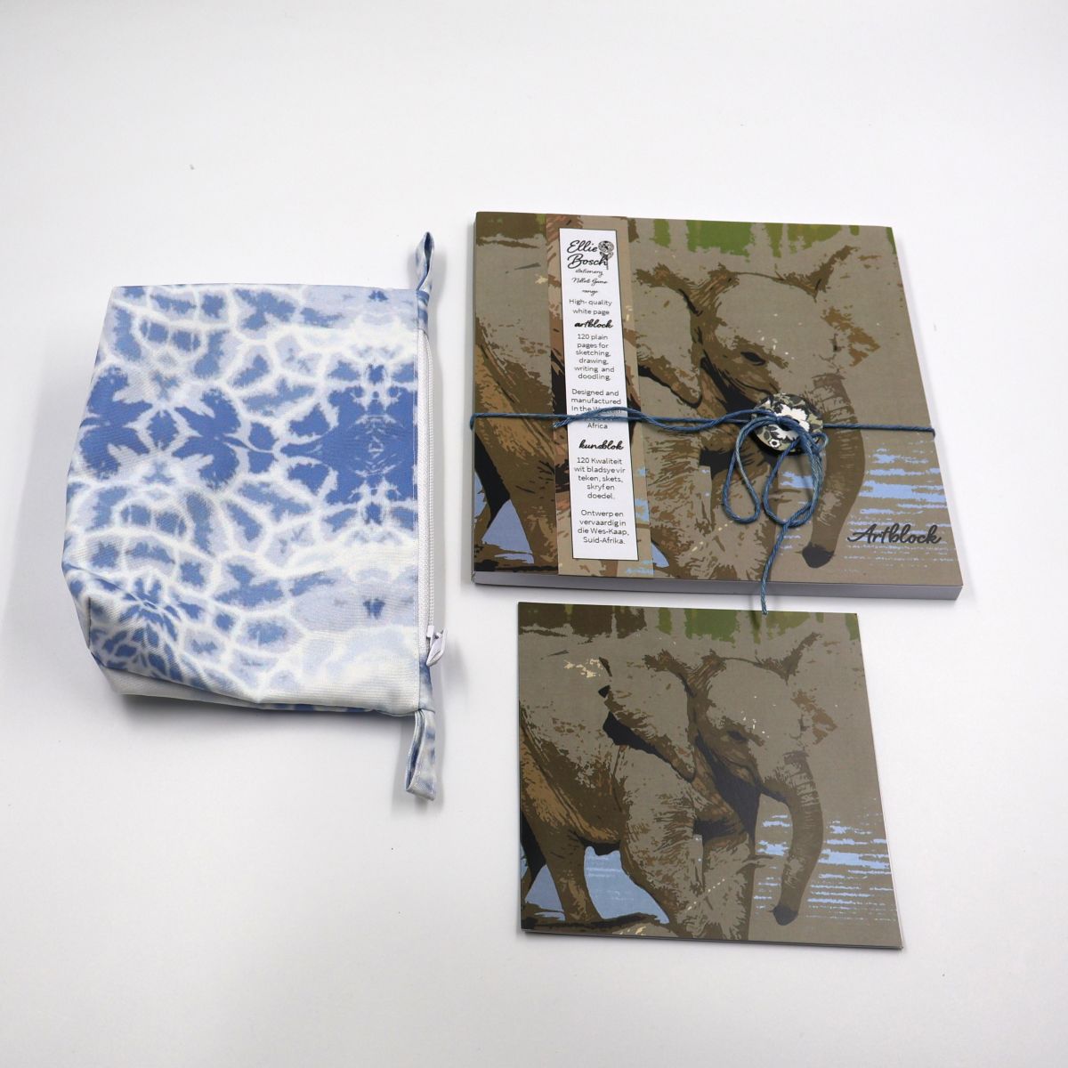 Individual wildlife stationery items shown separately flat lay style including a thick paper square twenty by twenty centimeter sketchpad a soft blue fabric pouch and card