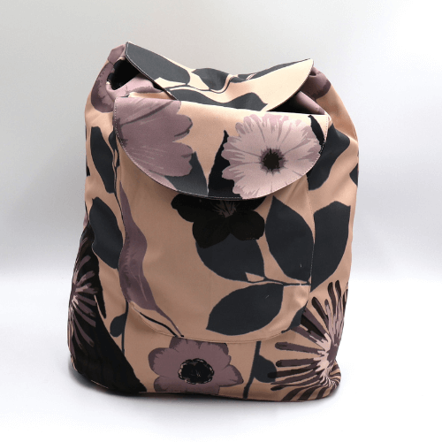 Lightweight backpack with drawstring and daisy floral design in mauve and dusky peach.